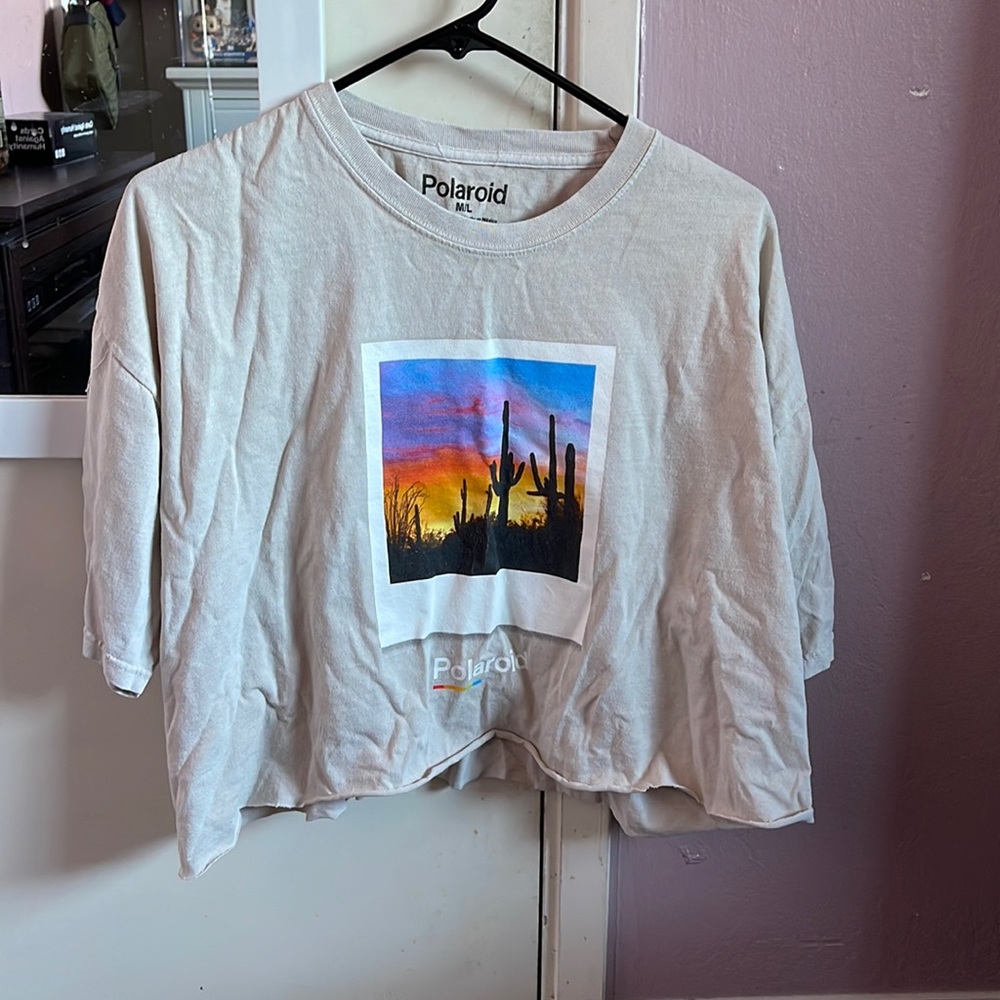 Tan crop top with cactus and a pretty sunset. Under that it says “Polaroid”